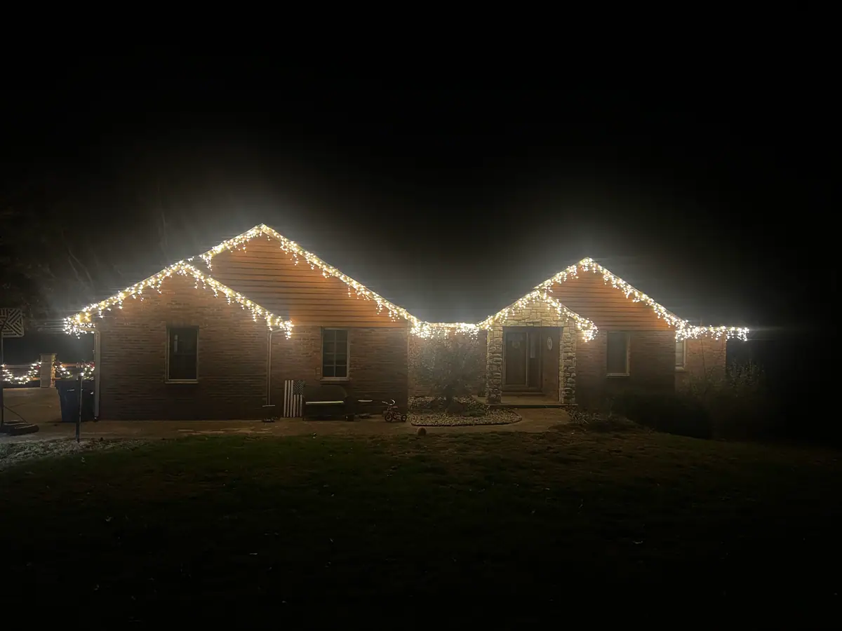 A single-story ranch outlined in classic warm white C9 lights